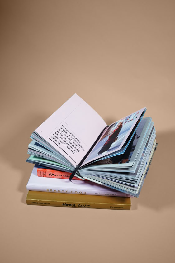 An open book resting on top of another book